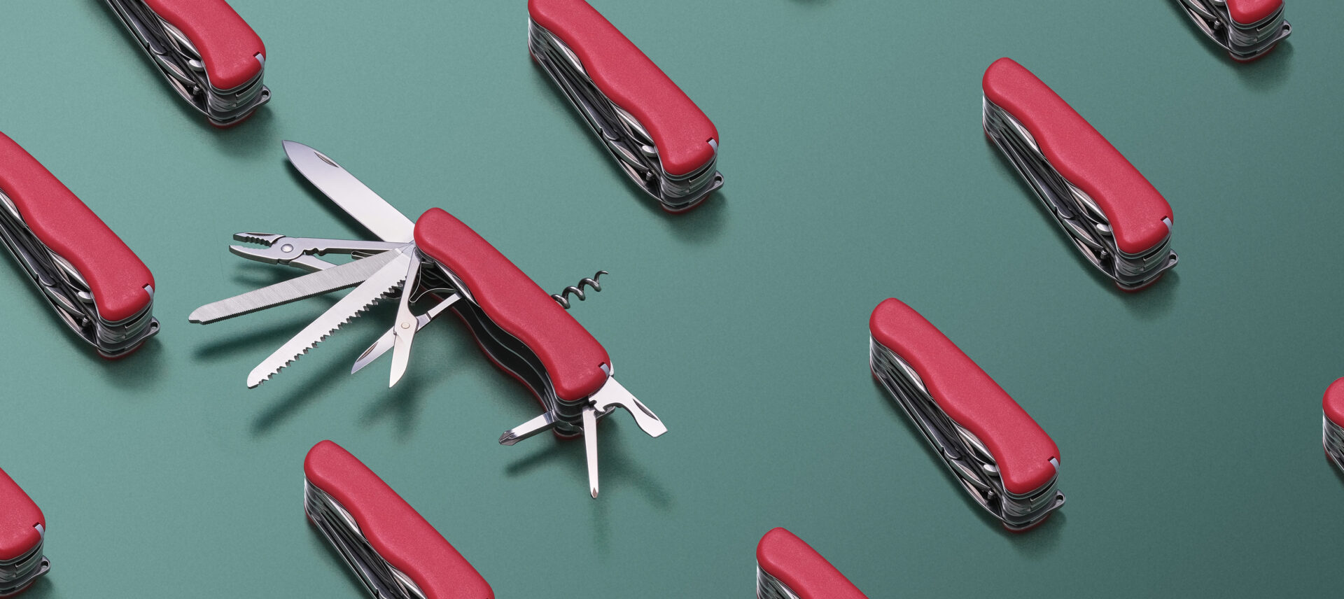 Swiss army knives on a green background